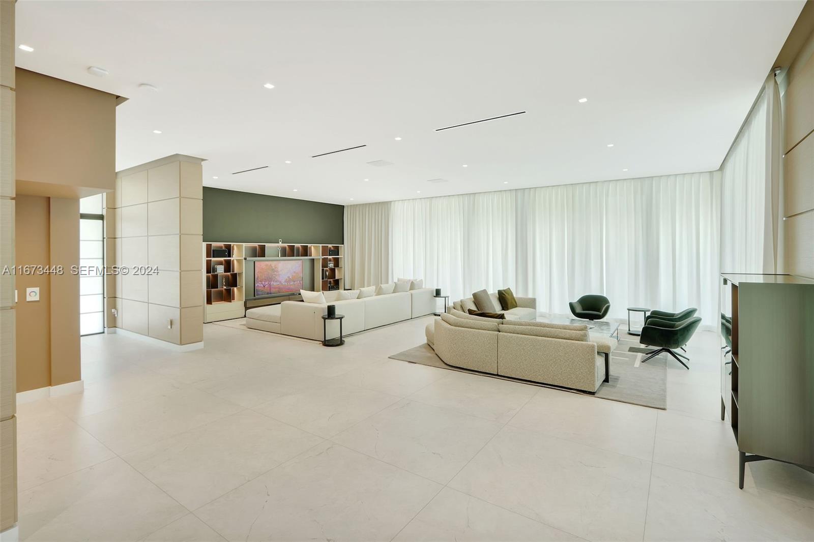 9860 Northeast 5th Avenue Road Miami Shores, FL 33138 - Photo 16 of 56 a bed room with furniture and a large window