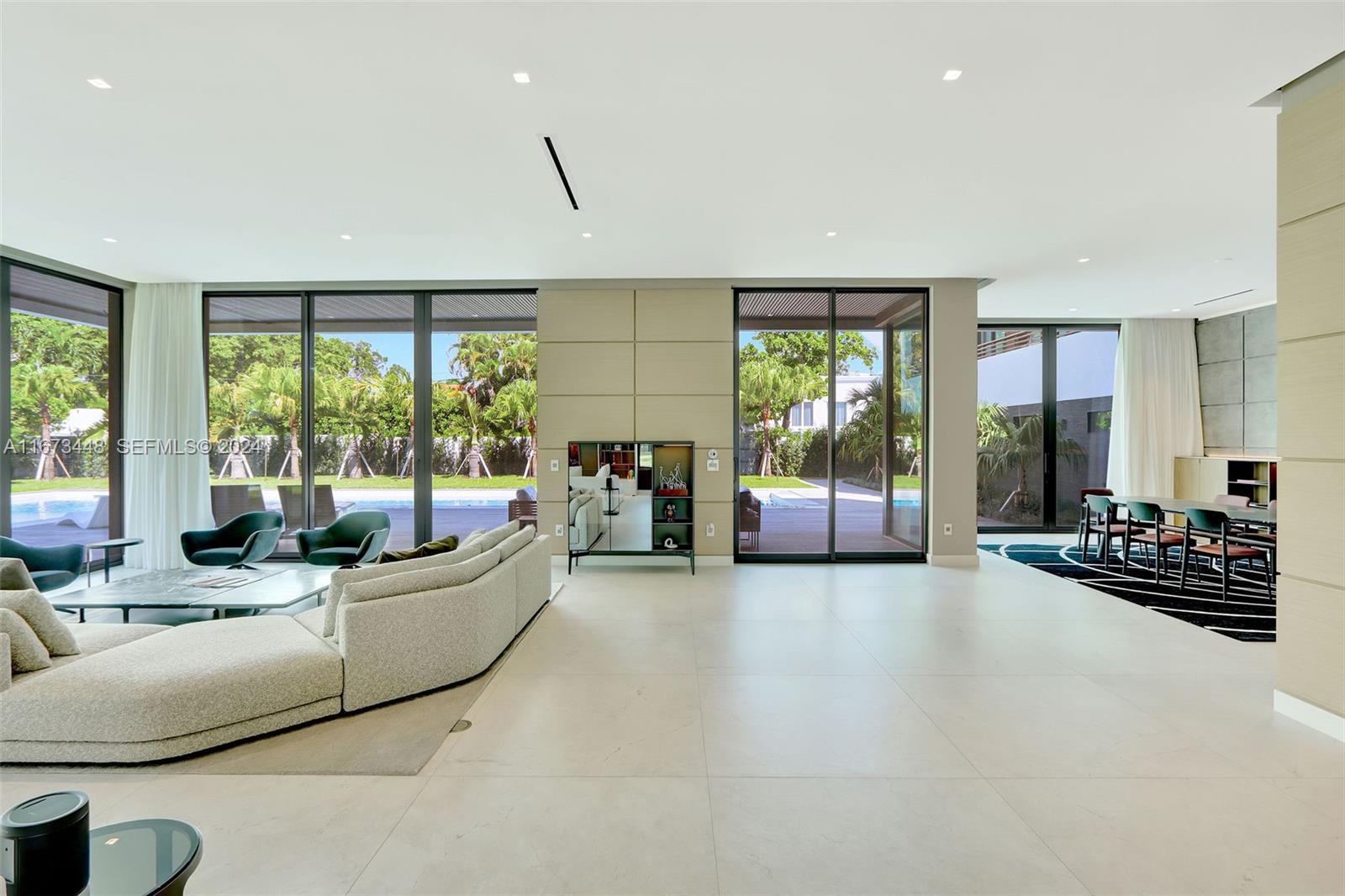 9860 Northeast 5th Avenue Road Miami Shores, FL 33138 - Photo 18 of 56 a living room with furniture and large windows