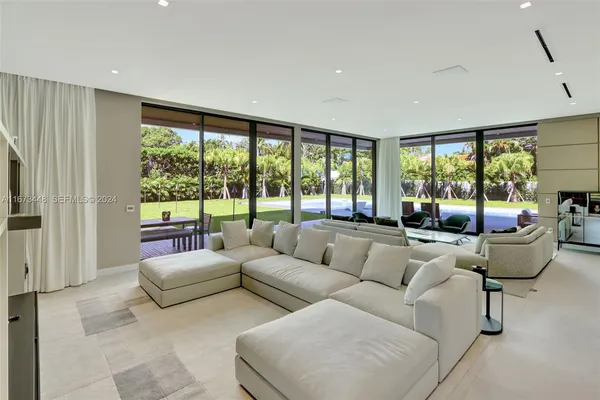 a view of a dining room with furniture and a chandelier