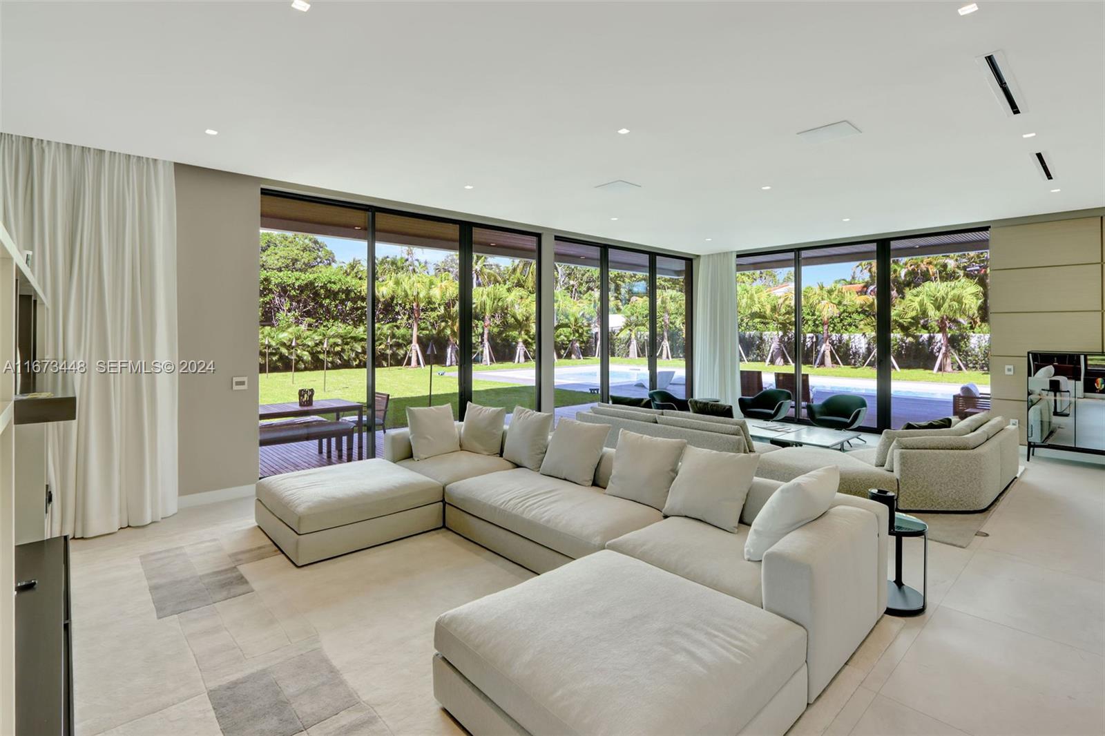 9860 Northeast 5th Avenue Road Miami Shores, FL 33138 - Photo 19 of 56 a living room with furniture and a large window