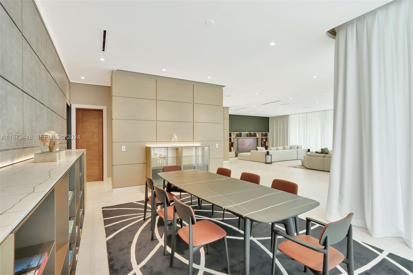 9860 Northeast 5th Avenue Road Miami Shores, FL 33138 - Photo 20 of 56 a view of a dining room with furniture and a chandelier
