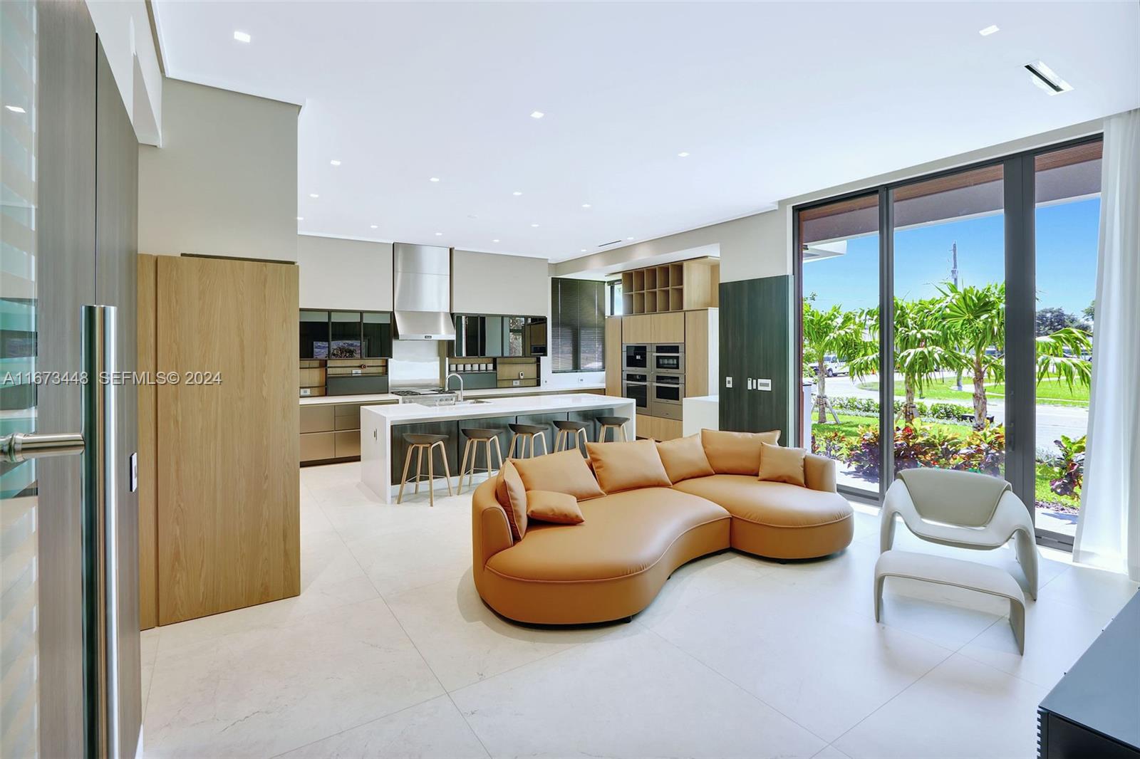 9860 Northeast 5th Avenue Road Miami Shores, FL 33138 - Photo 22 of 56 a living room with furniture and a large window