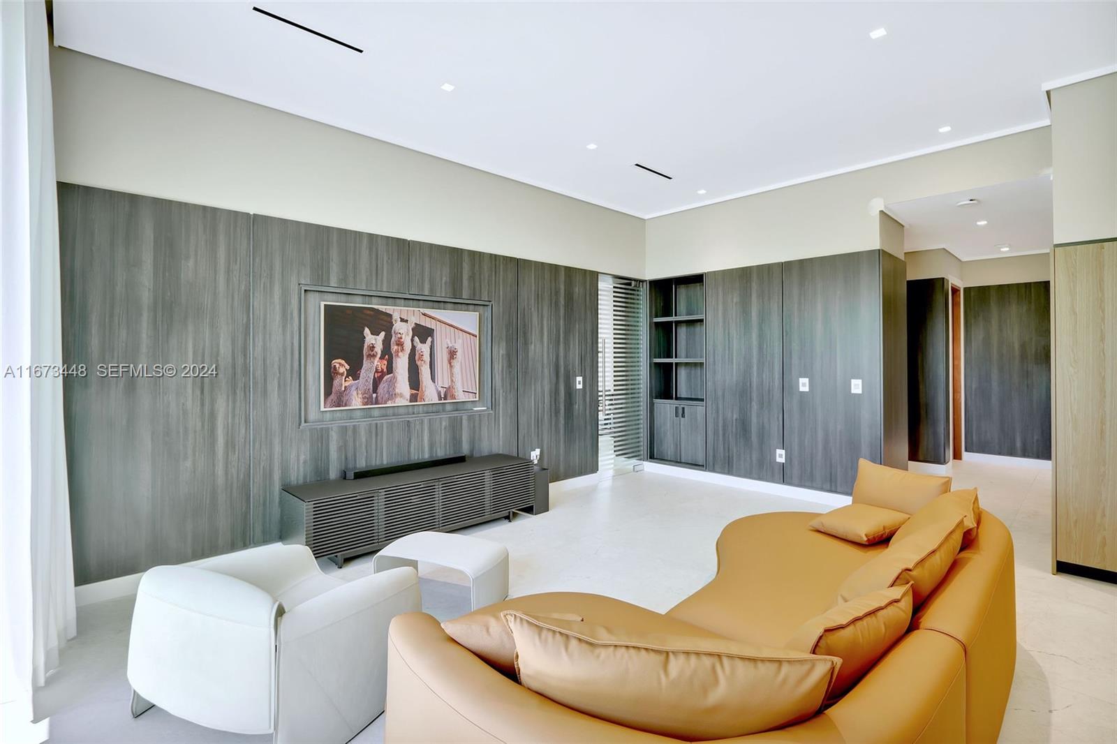 9860 Northeast 5th Avenue Road Miami Shores, FL 33138 - Photo 23 of 56 a living room with furniture and a large mirror