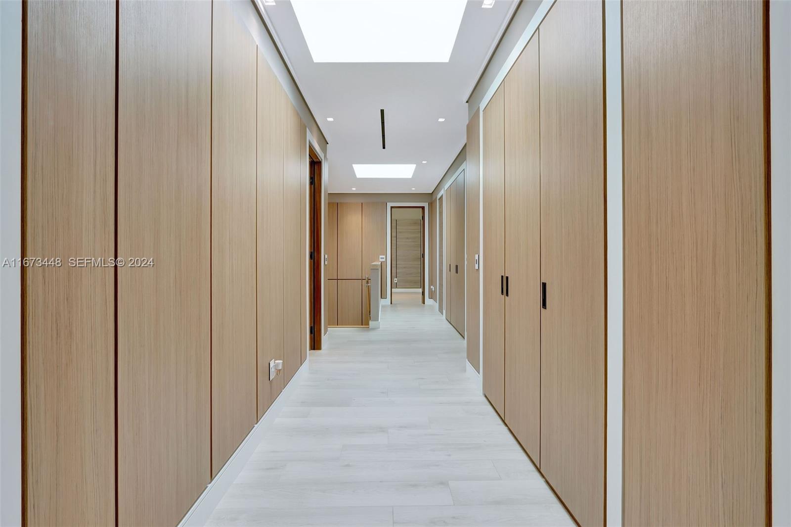 9860 Northeast 5th Avenue Road Miami Shores, FL 33138 - Photo 30 of 56 a view of a hallway with wooden floor and entryway