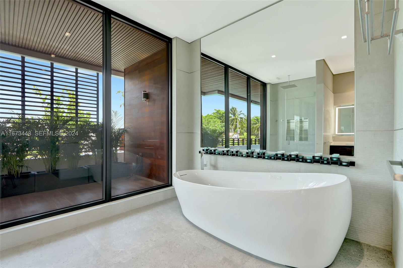9860 Northeast 5th Avenue Road Miami Shores, FL 33138 - Photo 37 of 56 a white bath tub sitting in a spacious bathroom
