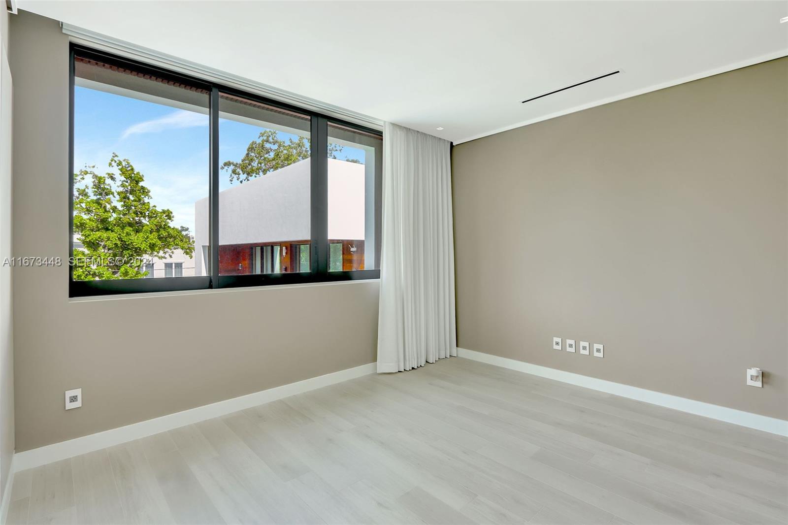 9860 Northeast 5th Avenue Road Miami Shores, FL 33138 - Photo 39 of 56 a view of an empty room with a window