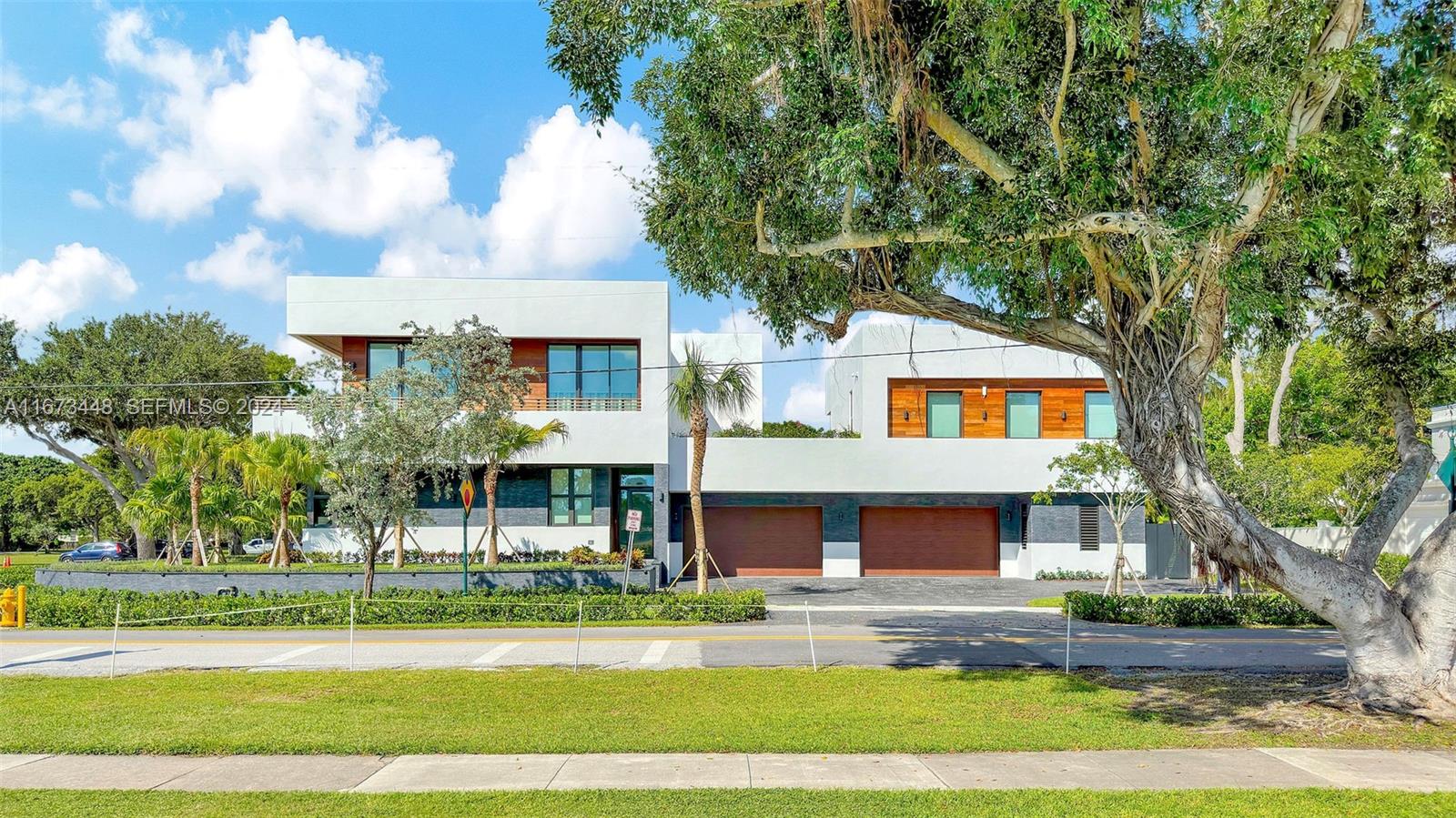9860 Northeast 5th Avenue Road Miami Shores, FL 33138 - Photo 4 of 56 a front view of a house with a yard