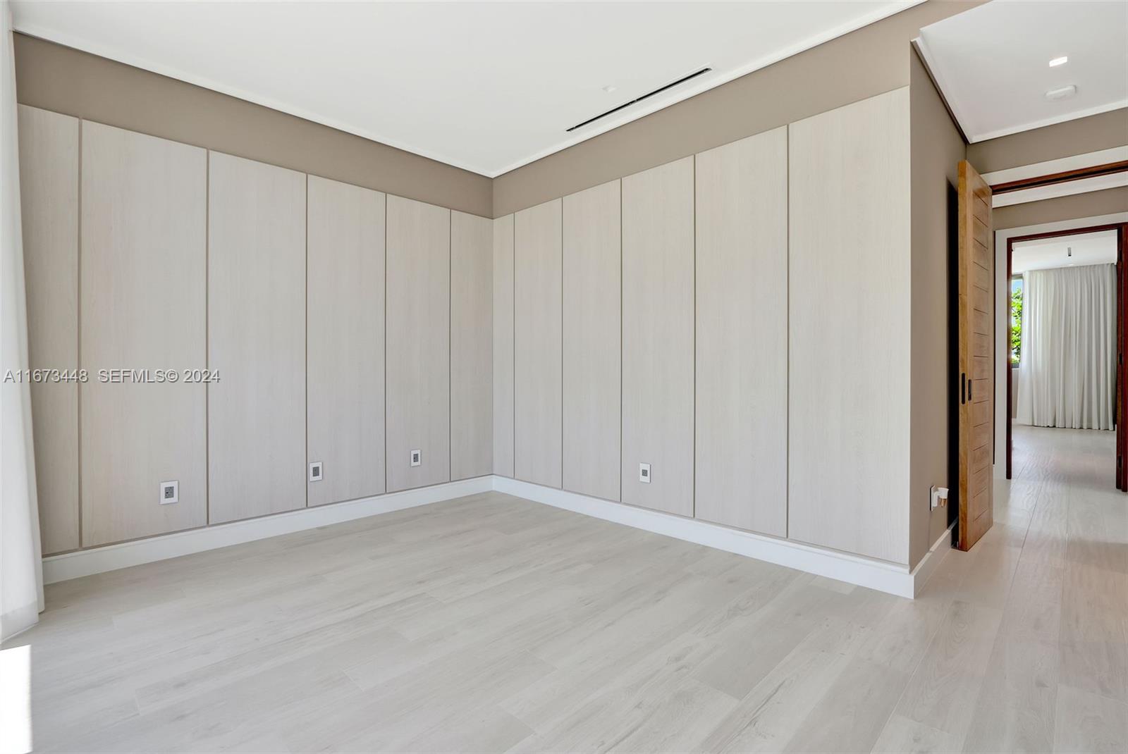9860 Northeast 5th Avenue Road Miami Shores, FL 33138 - Photo 41 of 56 a view of an empty room with wooden floor