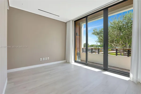an empty room with large windows