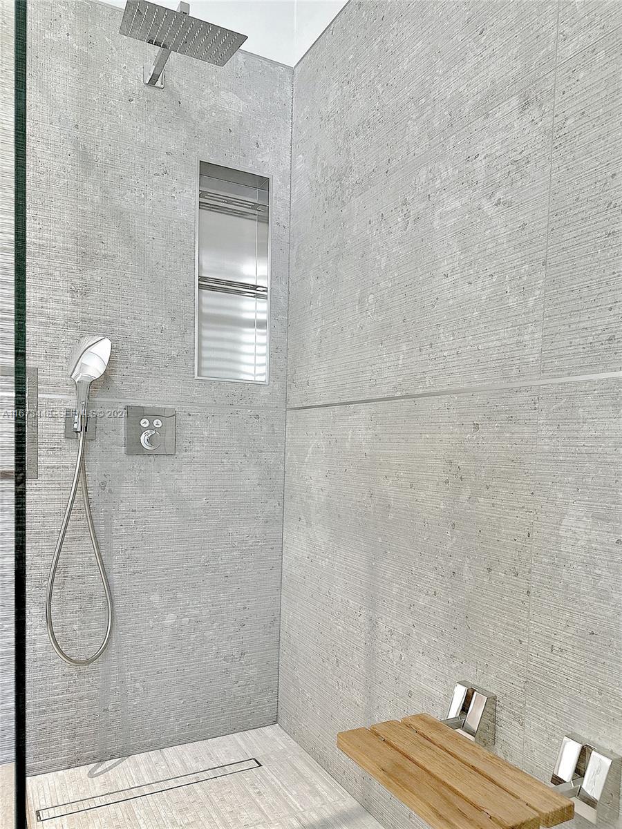 9860 Northeast 5th Avenue Road Miami Shores, FL 33138 - Photo 44 of 56 a bathroom with a glass shower door
