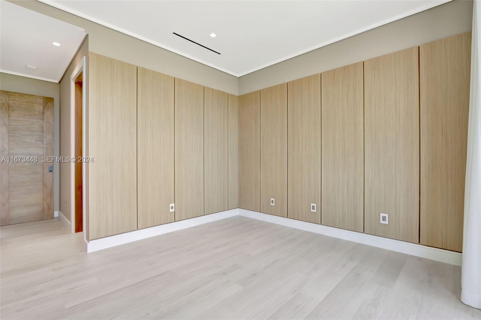 9860 Northeast 5th Avenue Road Miami Shores, FL 33138 - Photo 45 of 56 a view of an empty room with wooden floor