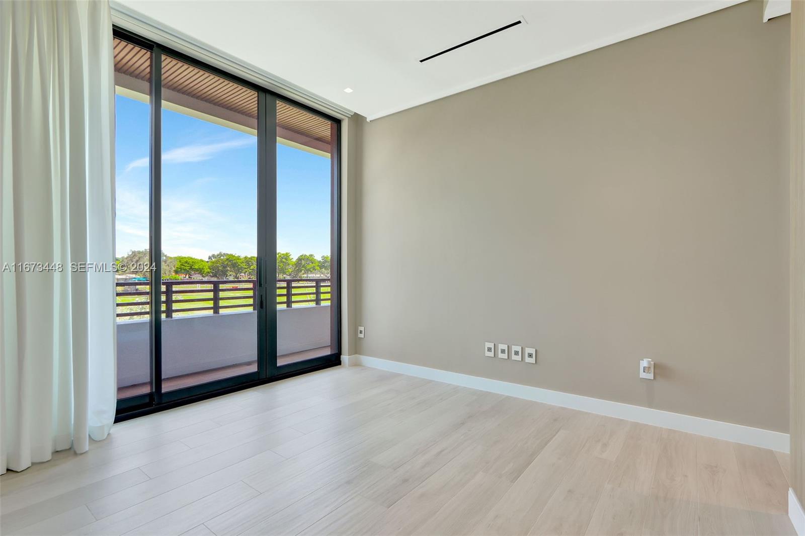 9860 Northeast 5th Avenue Road Miami Shores, FL 33138 - Photo 46 of 56 an empty room with large windows