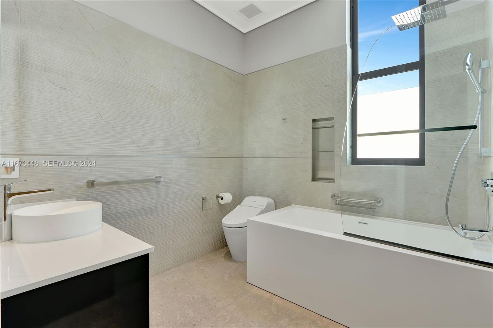 9860 Northeast 5th Avenue Road Miami Shores, FL 33138 - Photo 47 of 56 a bathroom with a sink and a bathtub