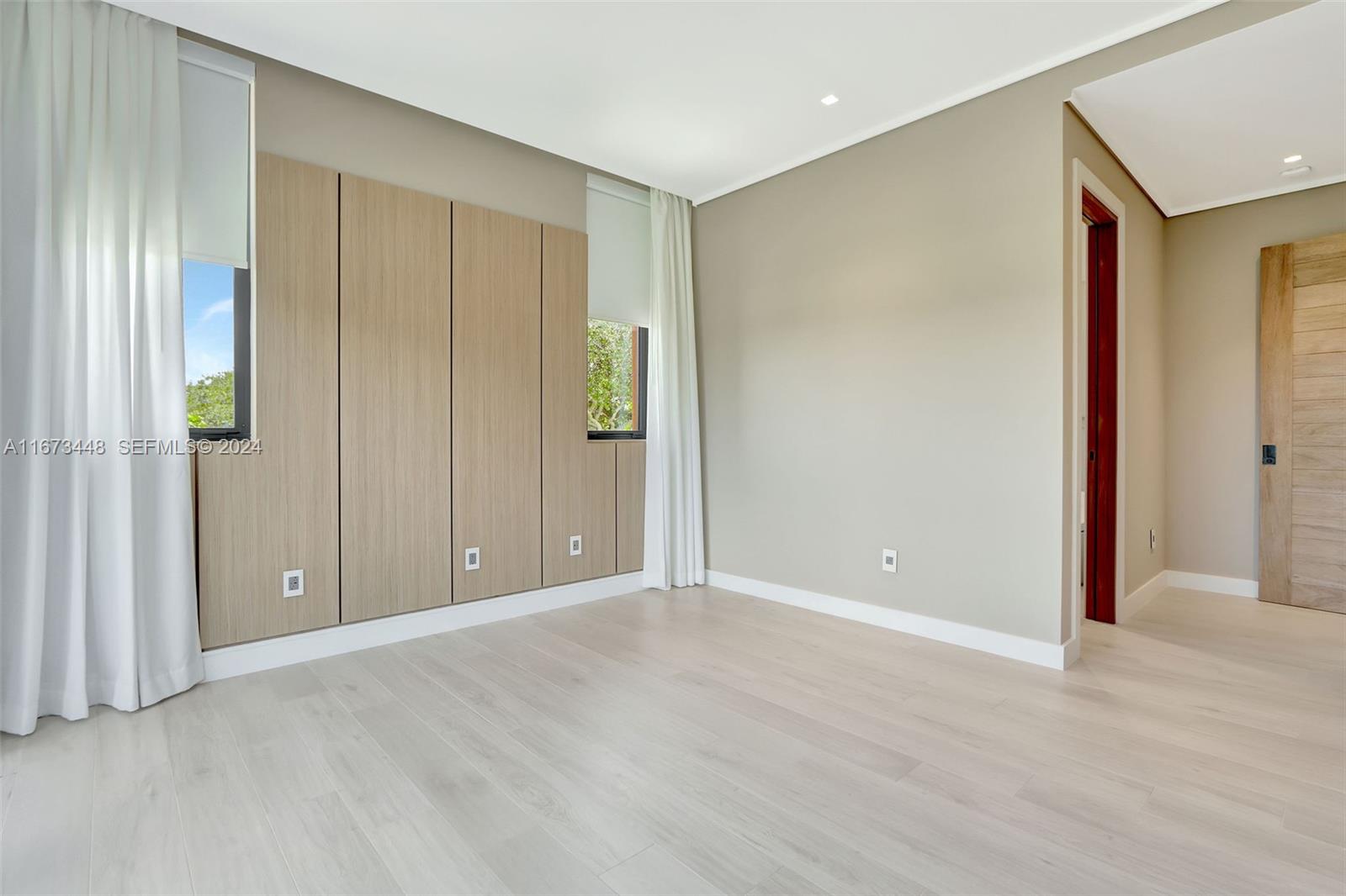 9860 Northeast 5th Avenue Road Miami Shores, FL 33138 - Photo 48 of 56 a view of an empty room with wooden floor