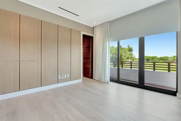 an empty room with windows and closet