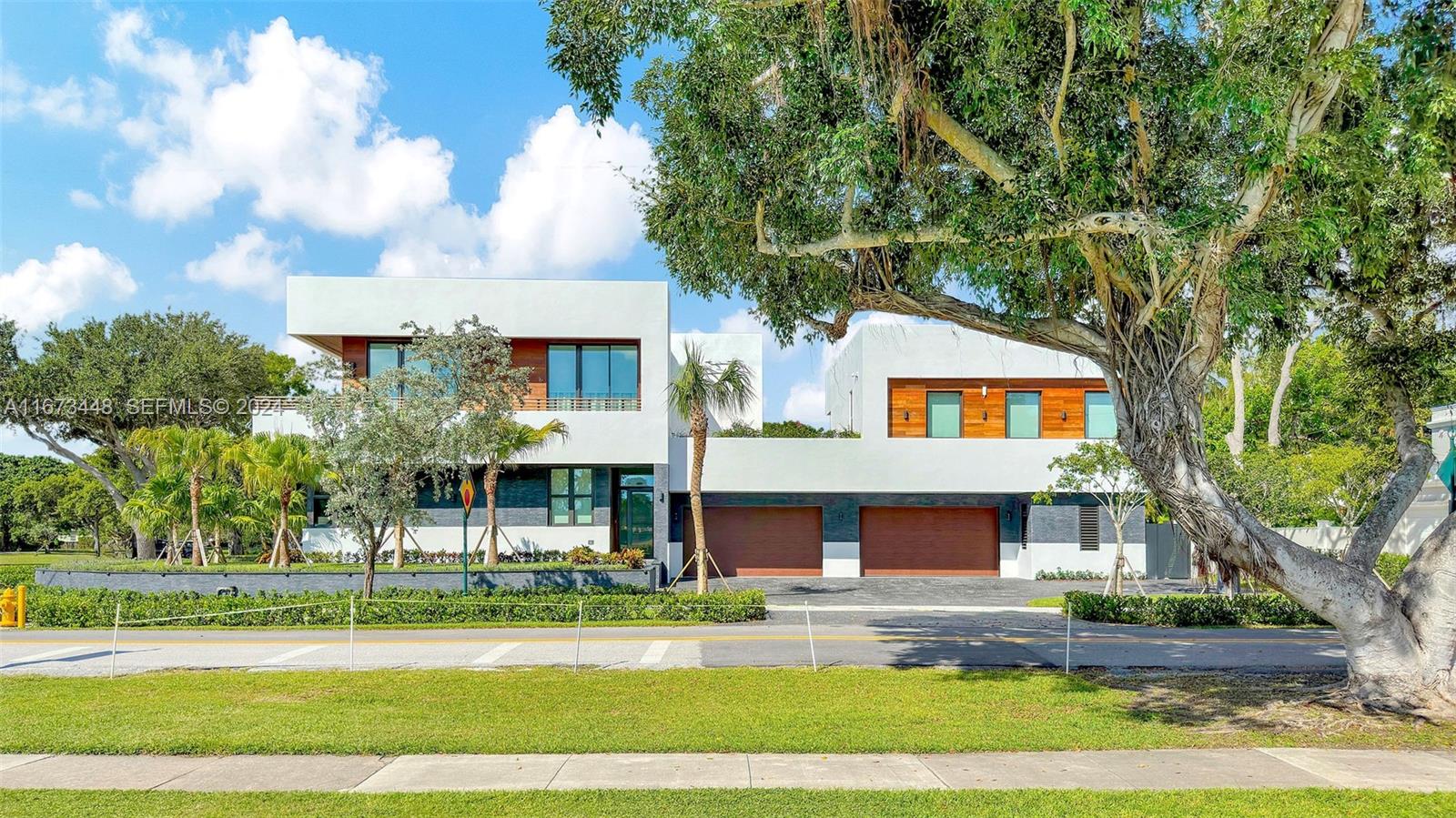 9860 Northeast 5th Avenue Road Miami Shores, FL 33138 - Photo 5 of 56 a front view of a house with a yard