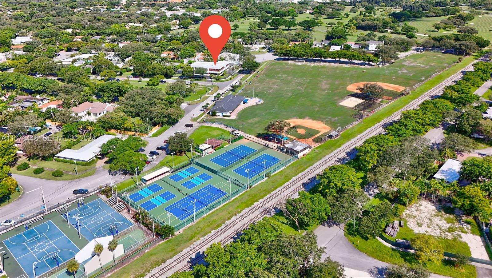 9860 Northeast 5th Avenue Road Miami Shores, FL 33138 - Photo 6 of 56 a view of a tennis ground and a houses