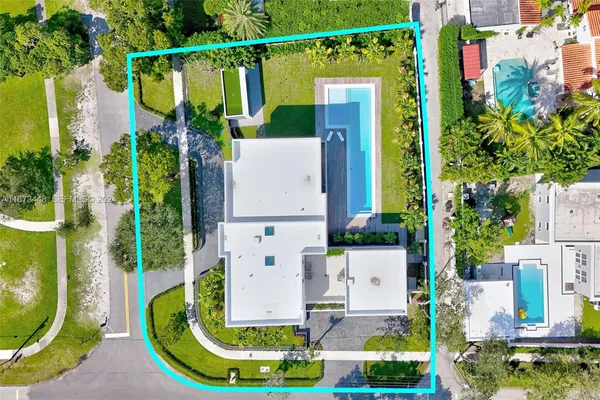 an aerial view of a house with a garden and swimming pool