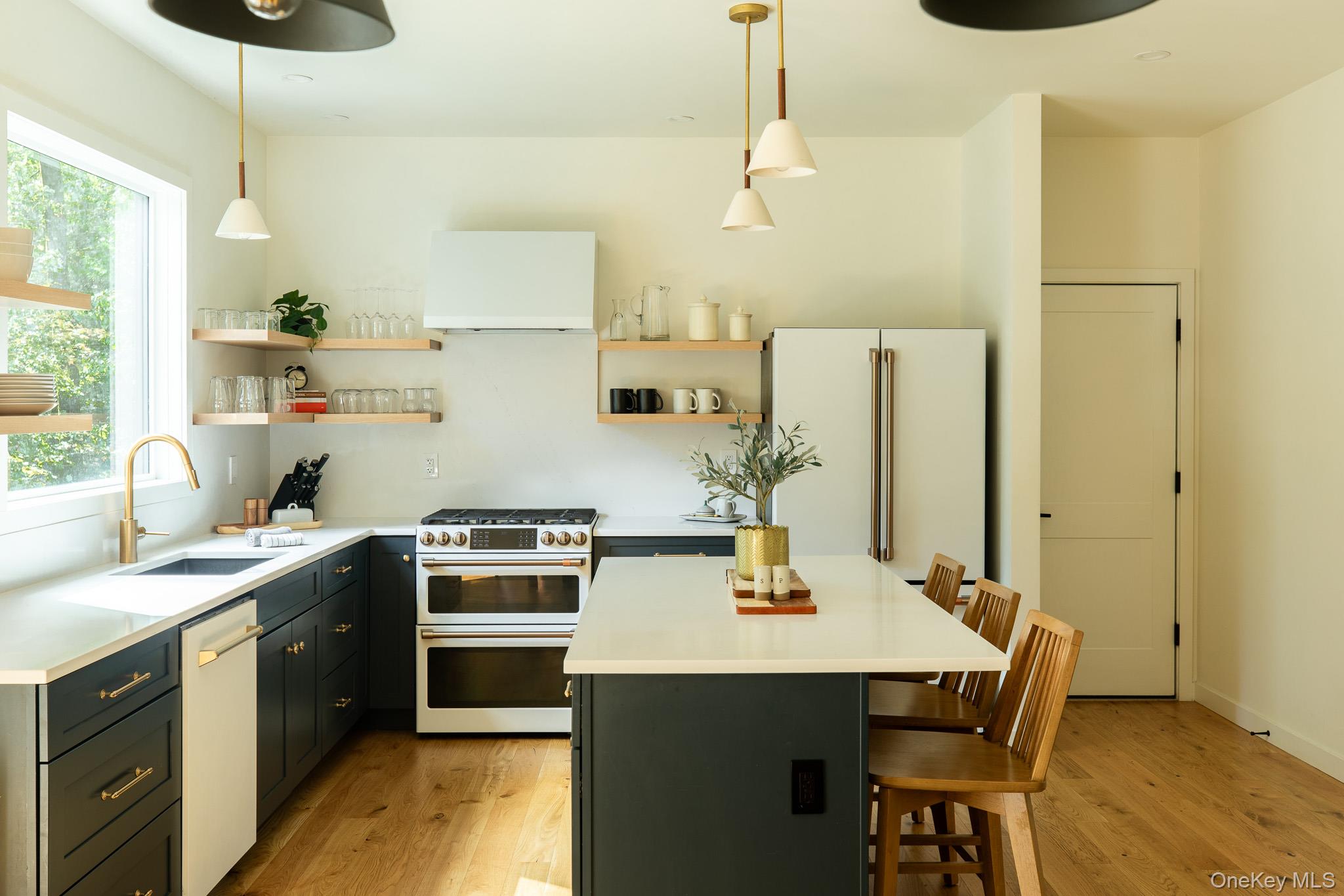 483 Acorn Hill Road Olivebridge, NY 12461 - Photo 15 of 50 Kitchen with range with two ovens, light wood finished floors, a center island, a kitchen bar, and decorative light fixtures