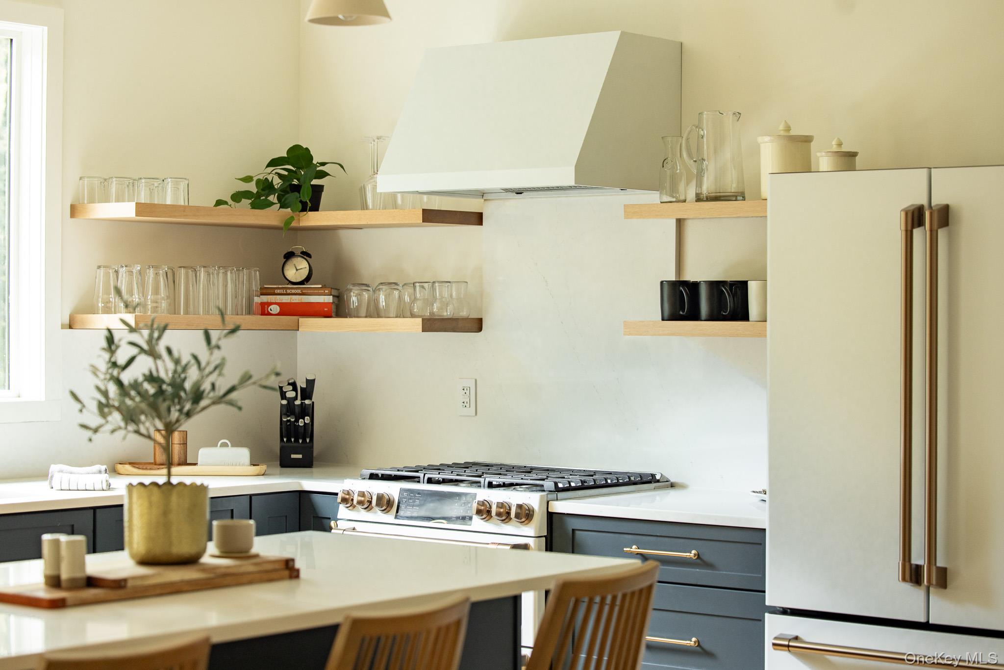 483 Acorn Hill Road Olivebridge, NY 12461 - Photo 16 of 50 Kitchen with freestanding refrigerator, gray cabinetry, custom exhaust hood, open shelves, and light stone counters