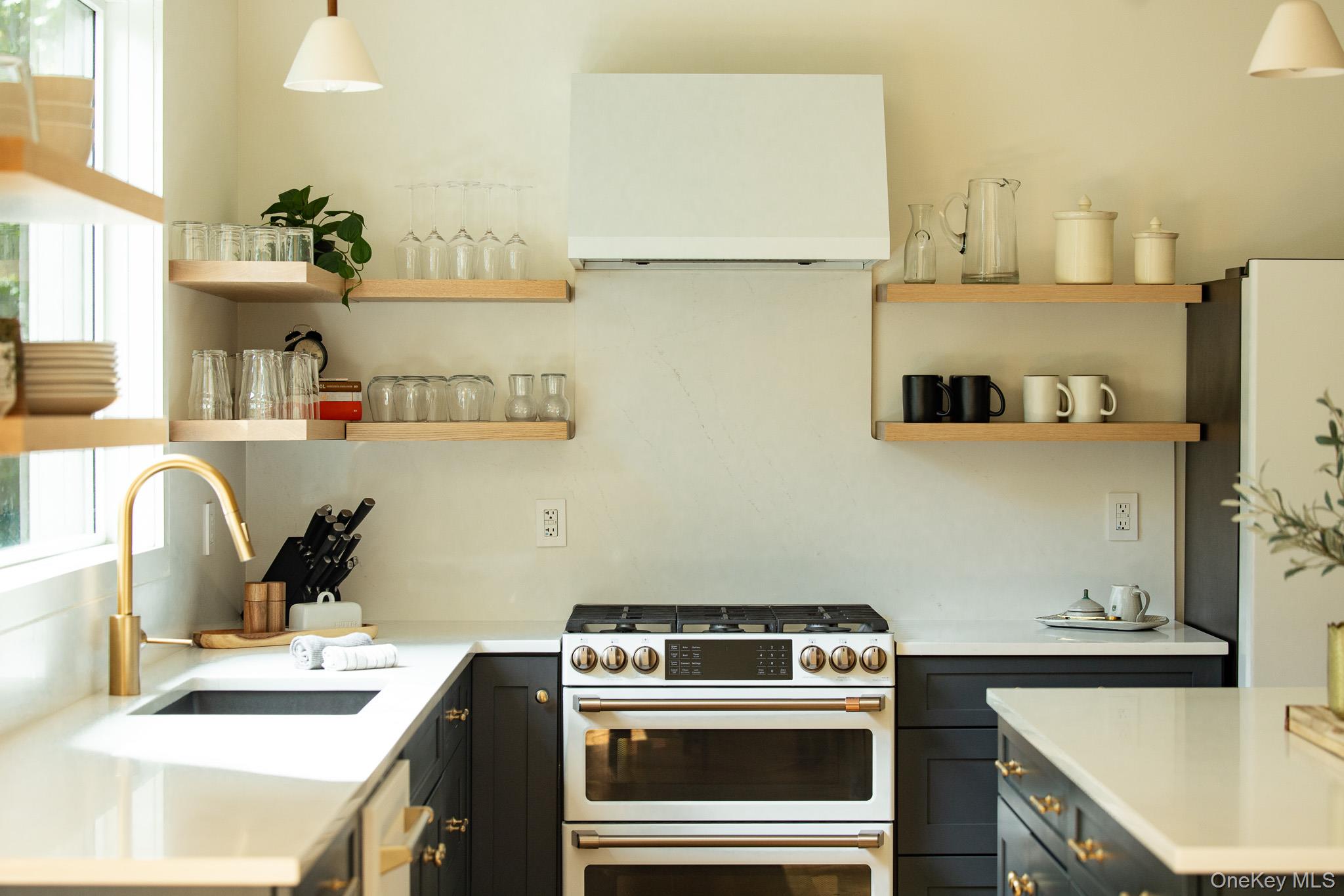 483 Acorn Hill Road Olivebridge, NY 12461 - Photo 17 of 50 Kitchen featuring gas range gas stove, open shelves, range hood, and light stone counters