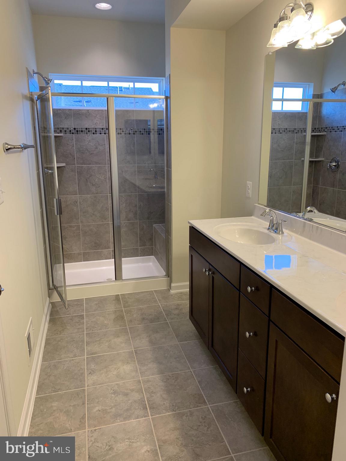 6113 Jefferson Pike Frederick, MD 21703 - Photo 6 of 12 a bathroom with a sink a mirror and a shower