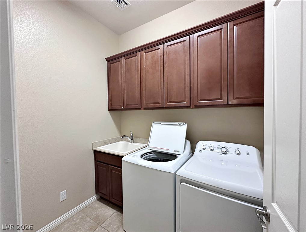 71 Newton Ridge Way Las Vegas, NV 89183 - Photo 38 of 40 Ample storage solutions and a utility sink equip this functional laundry area.