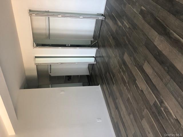 2 Richmond Road, Unit 6F Lido Beach, NY 11561 - Photo 4 of 14 Unfurnished bedroom featuring multiple closets and dark wood-style floors