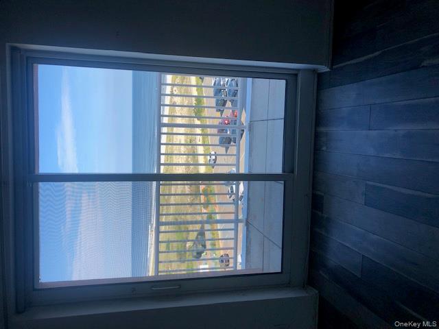 2 Richmond Road, Unit 6F Lido Beach, NY 11561 - Photo 6 of 14 Doorway with hardwood / wood-style flooring and view of water and beach