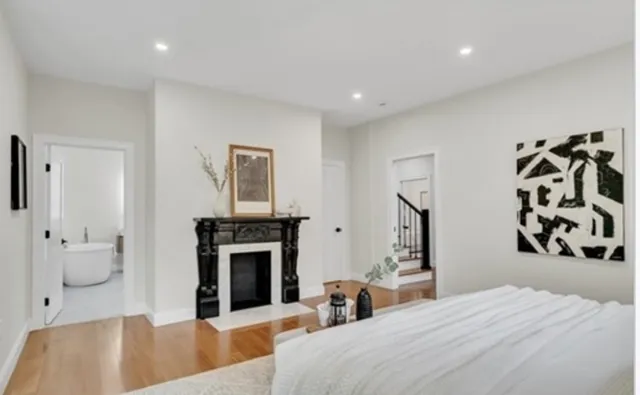 a bedroom with a bed and a fireplace