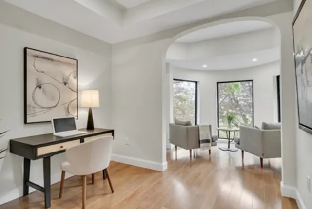 a view of a livingroom with furniture window and wooden floor