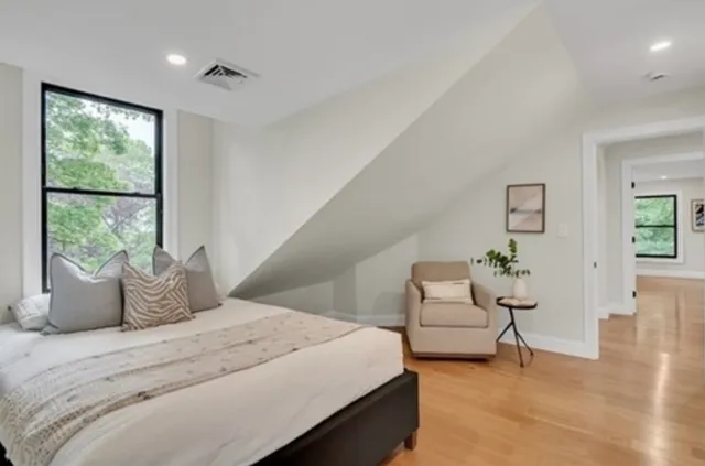 a bedroom with a balcony a bed and a couch