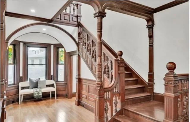 a view of entryway and hall with wooden floor