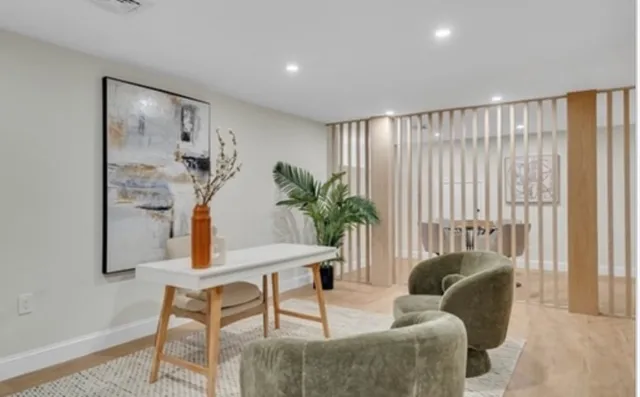a living room with furniture and a potted plant