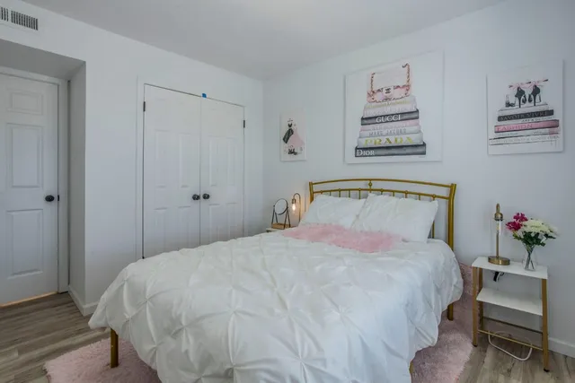 a bedroom with a bed and a closet