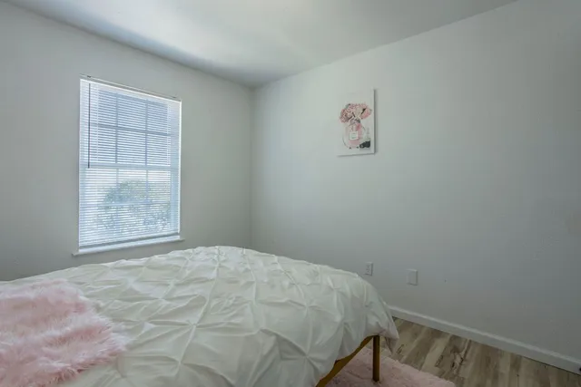a bedroom with a bed and a window