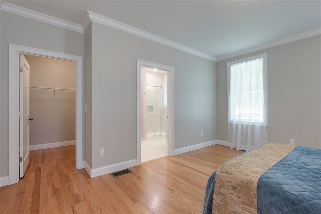 531 Clark Street Gardner, MA 01440 - Photo 15 of 42 a bedroom with a bed and wooden floor