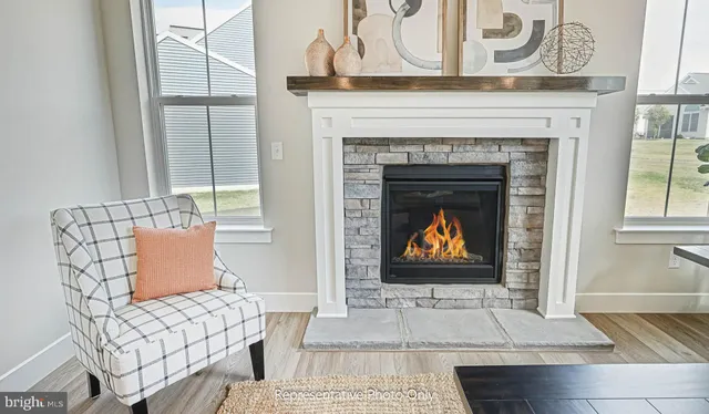 a living room with furniture a fireplace and a table