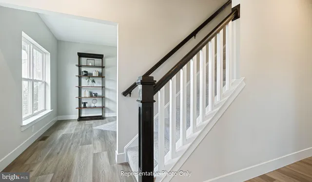 a view of a workspace room with furniture and wooden floor