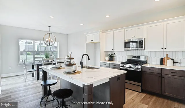 a kitchen with a dining table and chairs