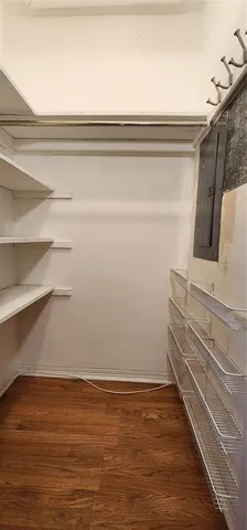 a view of a room with wooden floor and cabinet