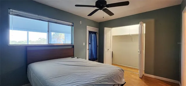 a bedroom with a bed and a window