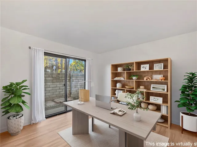 a room with furniture and potted plants