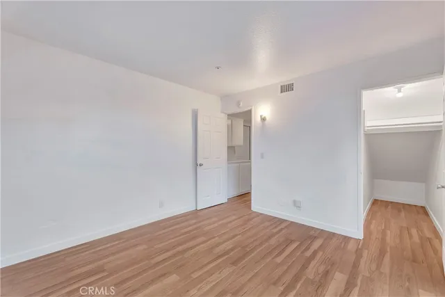a view of an empty room with wooden floor