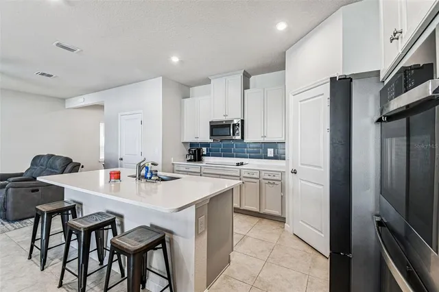 a kitchen with a sink appliances and cabinets