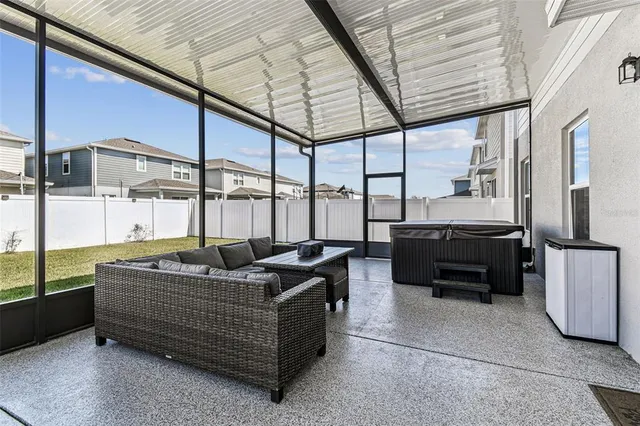 a roof deck with couch and chairs