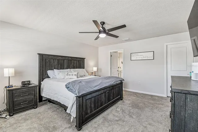 a bedroom with a bed and ceiling fan