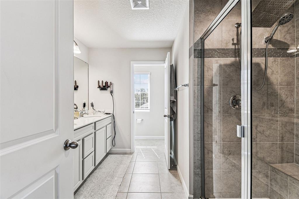 19043 Pebble Wood Ln Spring Hill Spring Hill, FL 34610 - Photo 21 of 35 a bathroom with a double vanity sink and mirror