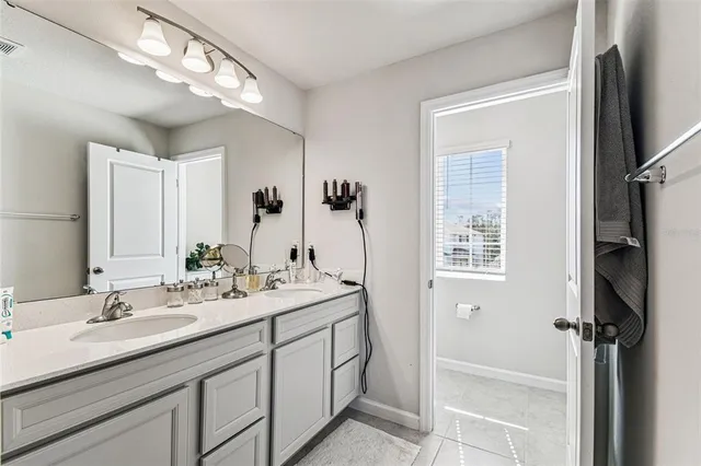 a bathroom with a double vanity sink a mirror and a shower