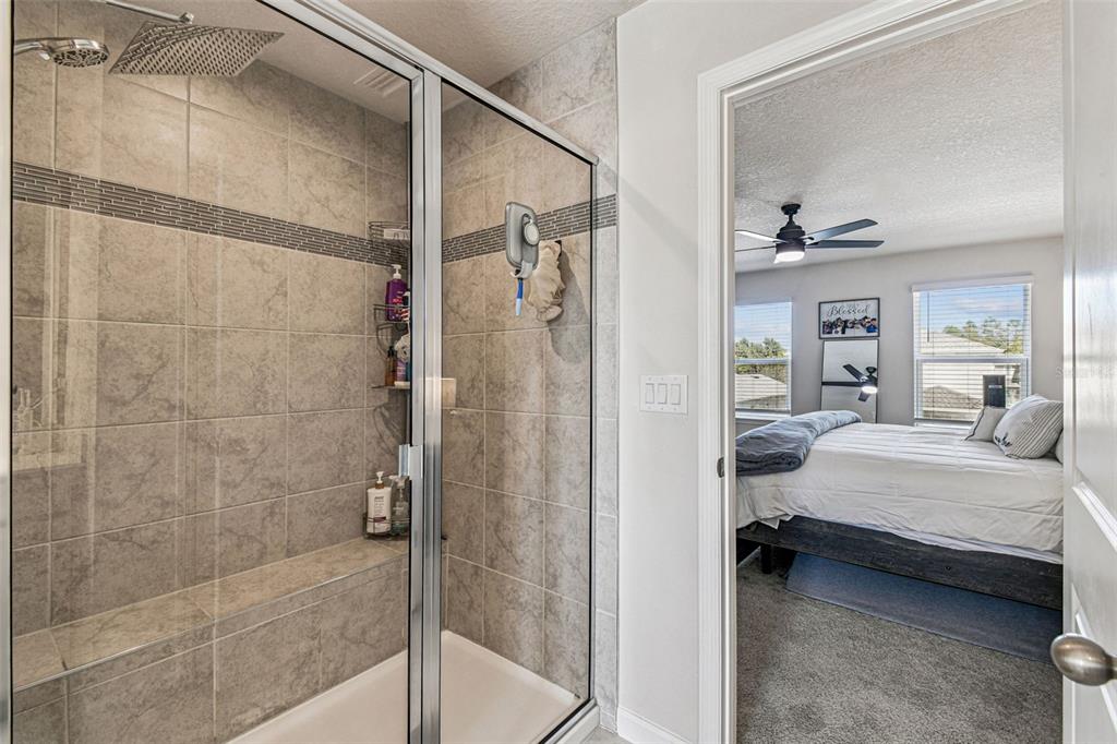 19043 Pebble Wood Ln Spring Hill Spring Hill, FL 34610 - Photo 23 of 35 a bedroom with a bed and a mirror